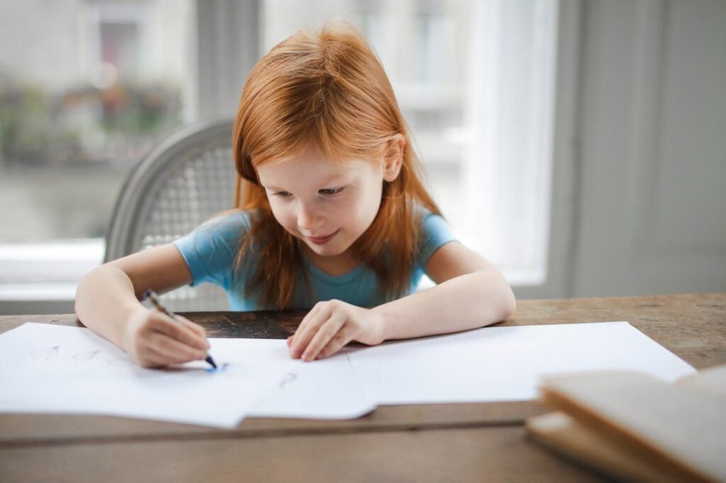 Young girl writing home work in her desk