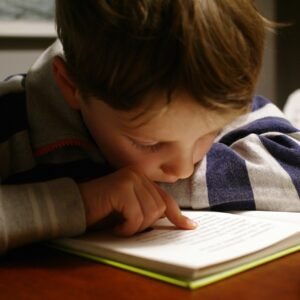 Boy reading book in a table