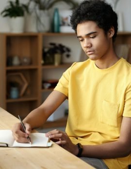 A student writing his home work